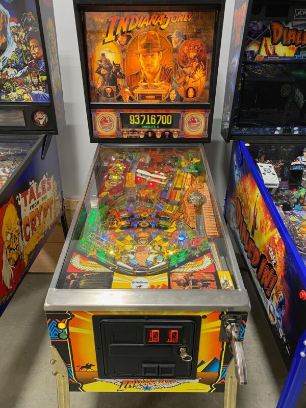 indiana jones pinball in a game room