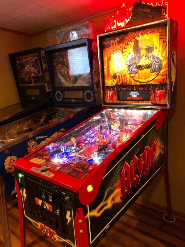 ac/dc pro pinball machine in a game room