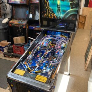 tron pinball machine in a game room