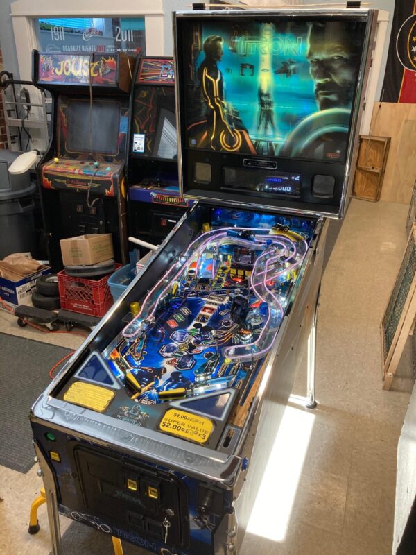 tron pinball machine in a game room