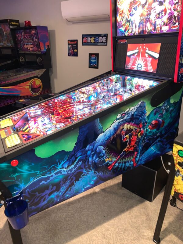 deadpool pinball machine in a game room